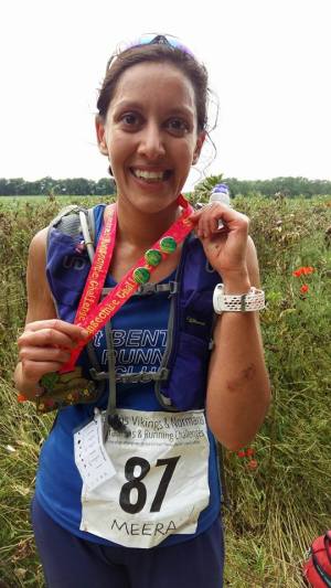 Ultra-marathoner Meera Rajoo-Oakley donning her medal and winner's badge